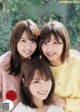 A group of three young women posing for a magazine cover.