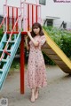 A woman standing in front of a colorful playground.